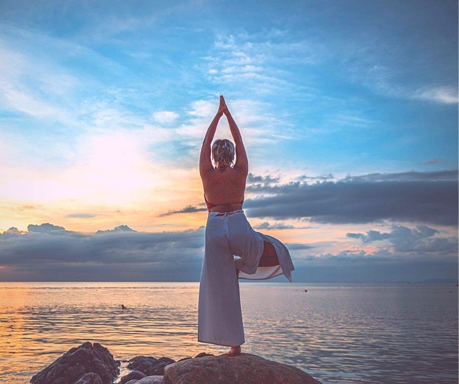 image of woman changing the story of her heath with yoga in nature