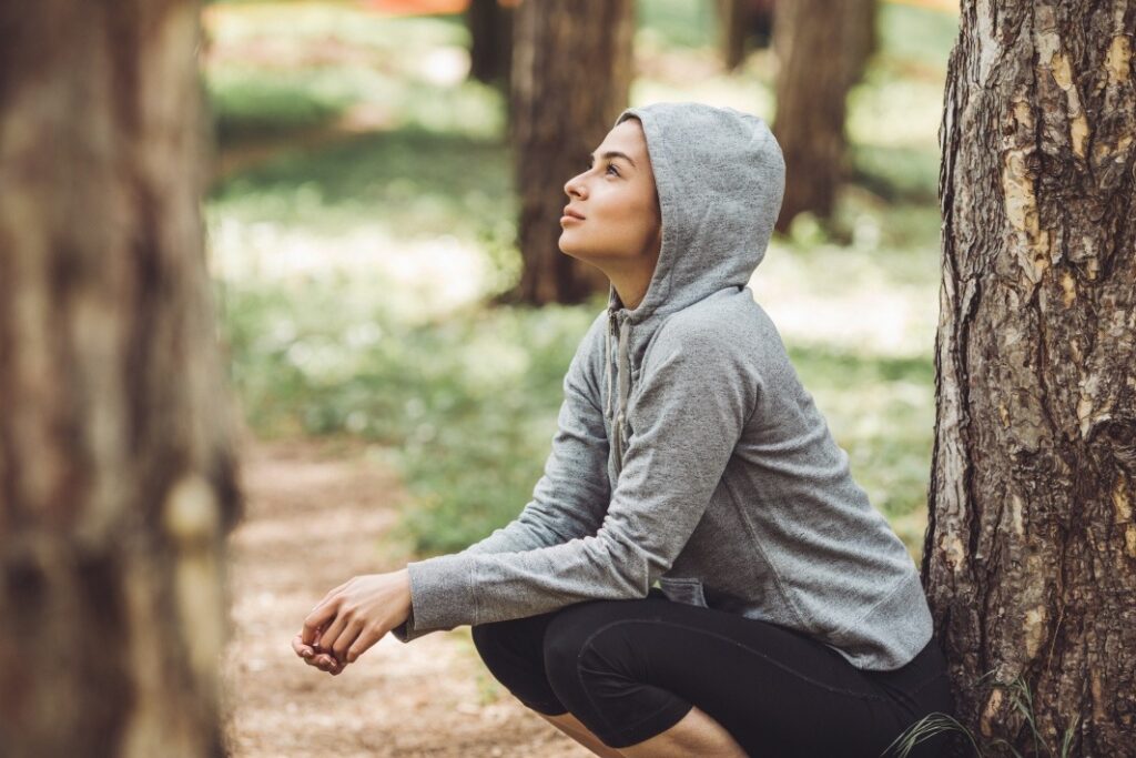 woman in hoodie illustrating habits that stick