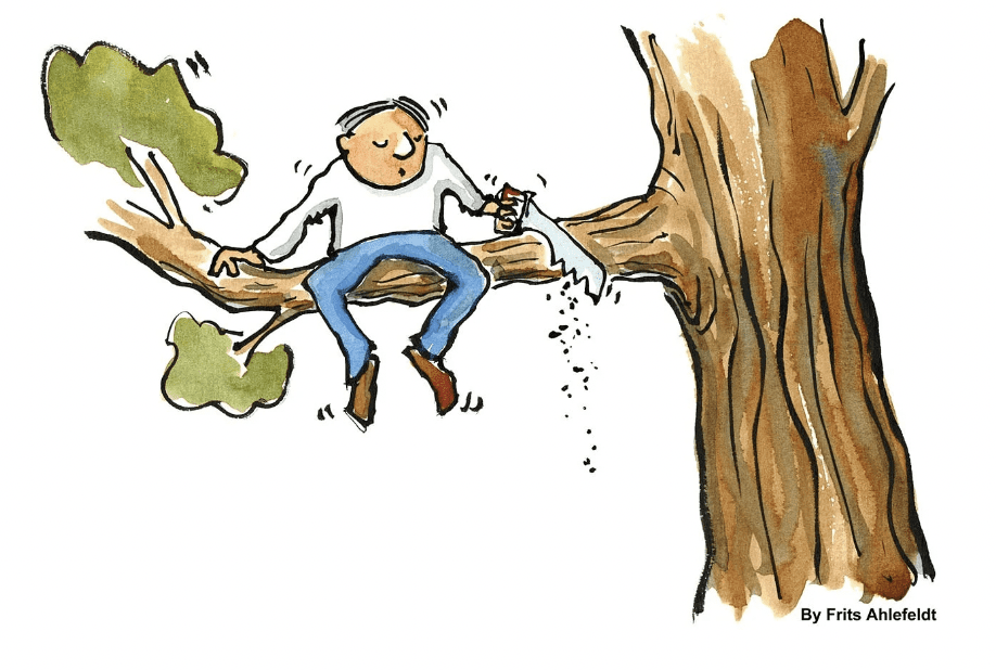 image of man sawing tree branch he's sitting on, illustrating the idea of self-sabotage, which can happen on the brink of success